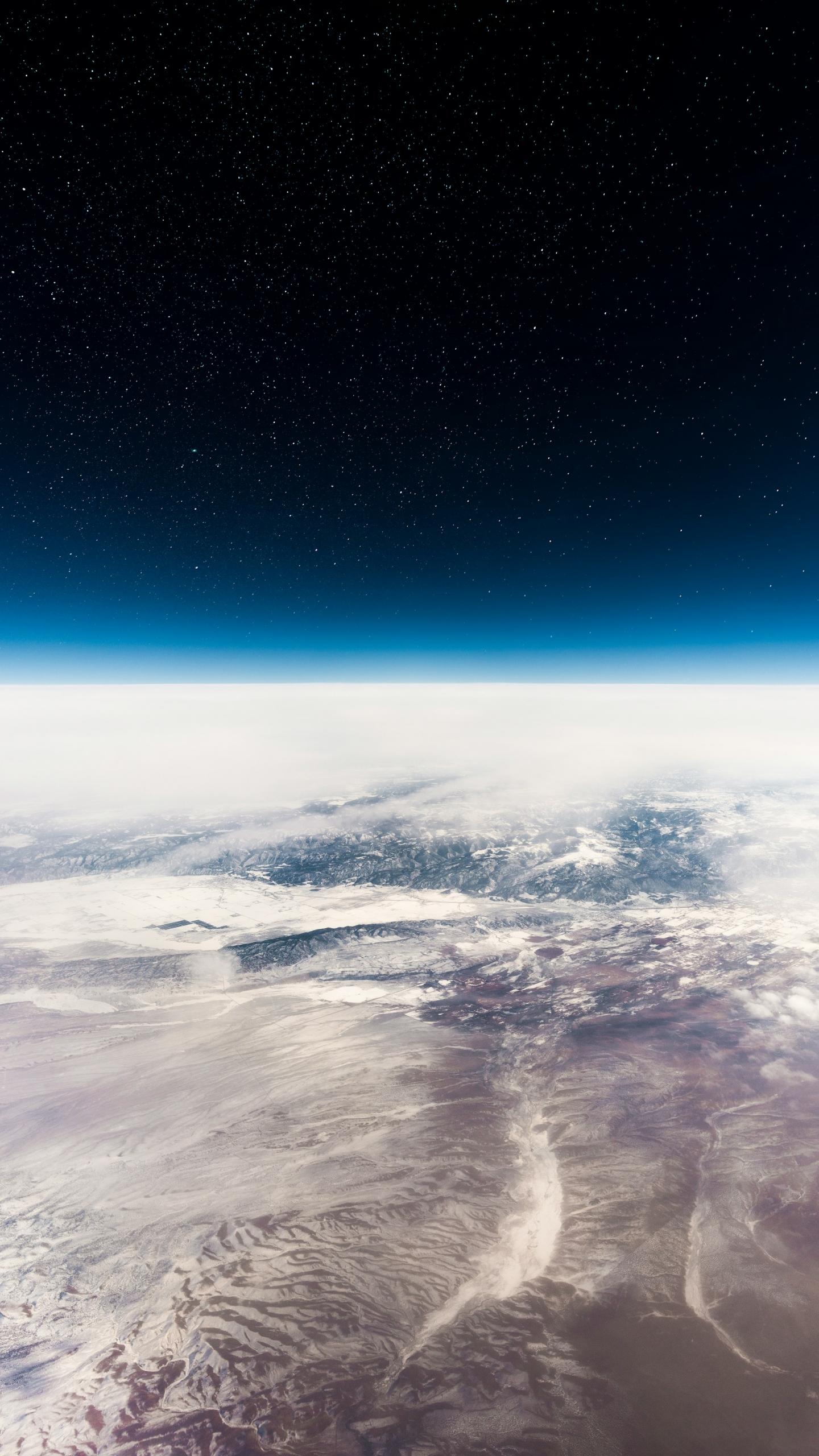 A view of Earth from space, shrouded in clouds.