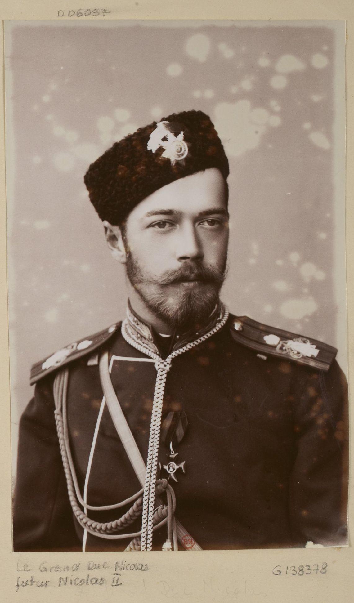 A sepia-toned image of a bearded man wearing a hat and military regalia.