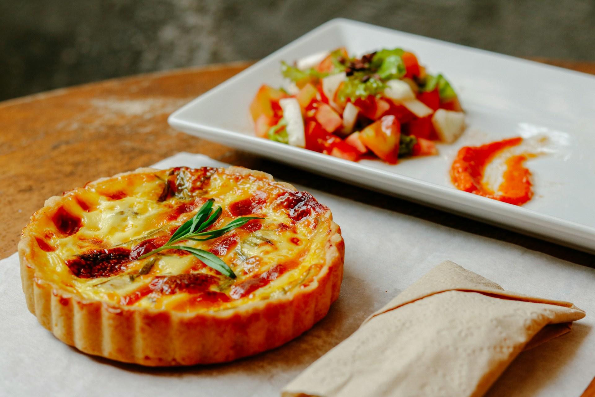 A mini quiche on a plate.