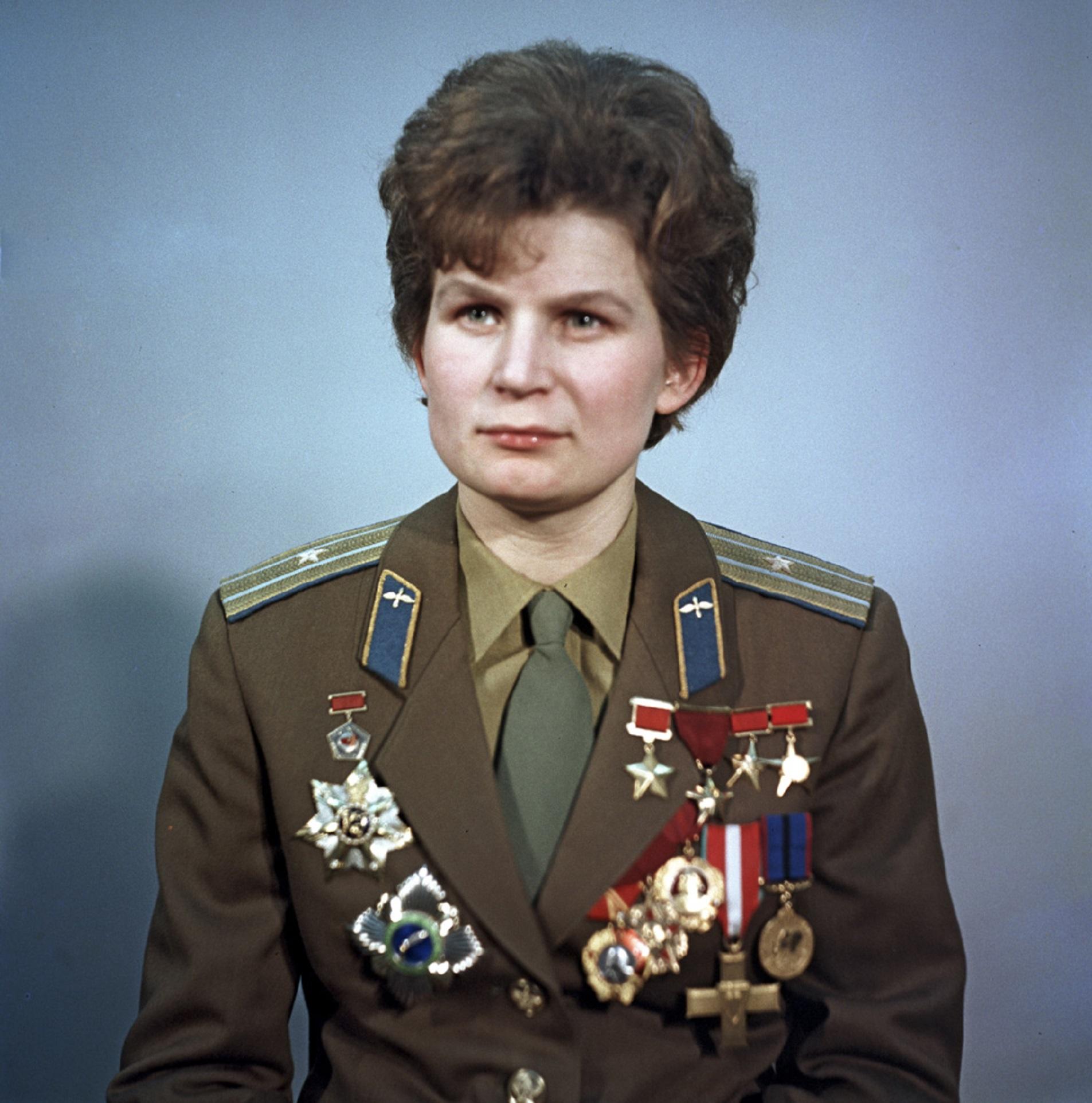 A woman wearing an olive drab military uniform with many medals pinned on.