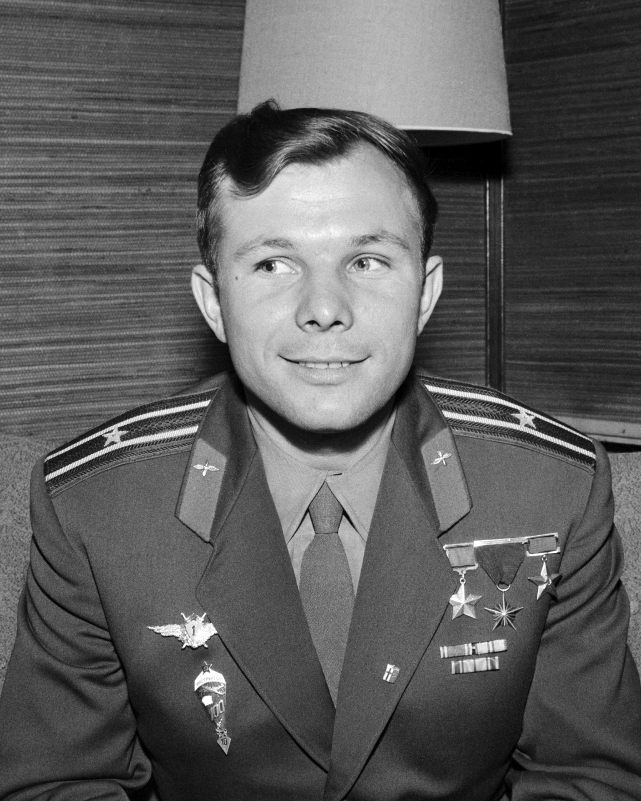 A greyscale image of a man wearing a military uniform and smiling.