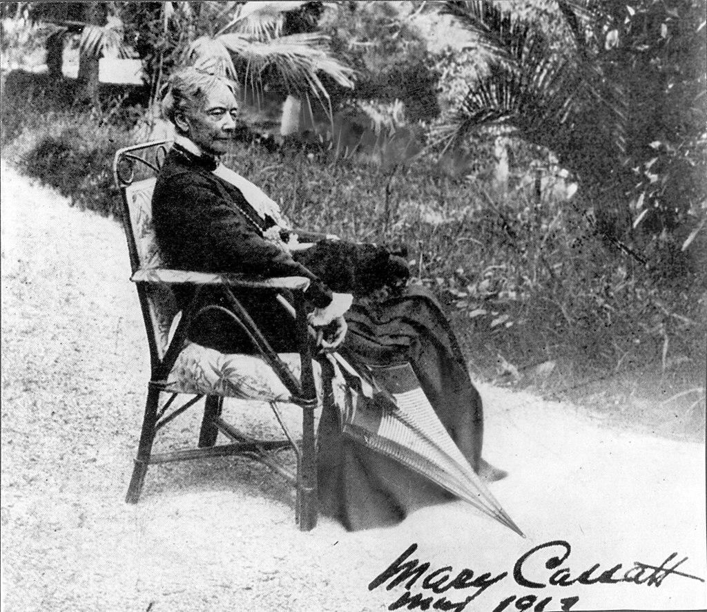 Cassatt seated in a chair with an umbrella. Verso reads "The only photograph for which she ever posed. Courtesy of Durand-Ruel."