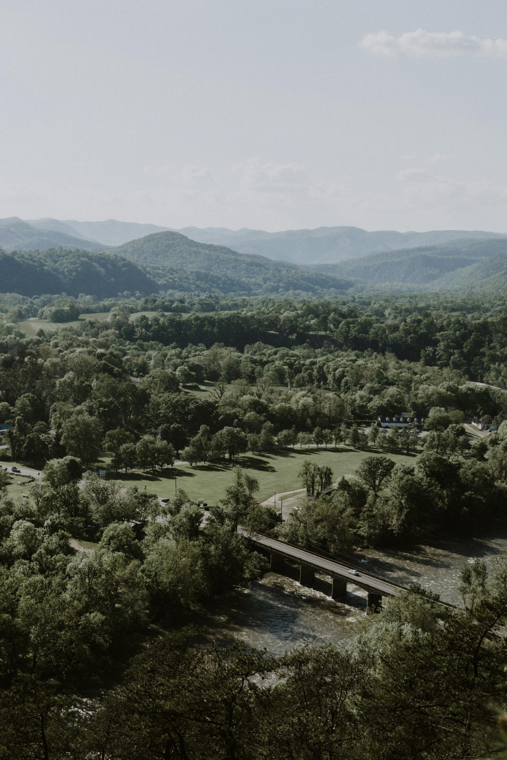 A rural area with a narrow bridge on a cloudy day. 