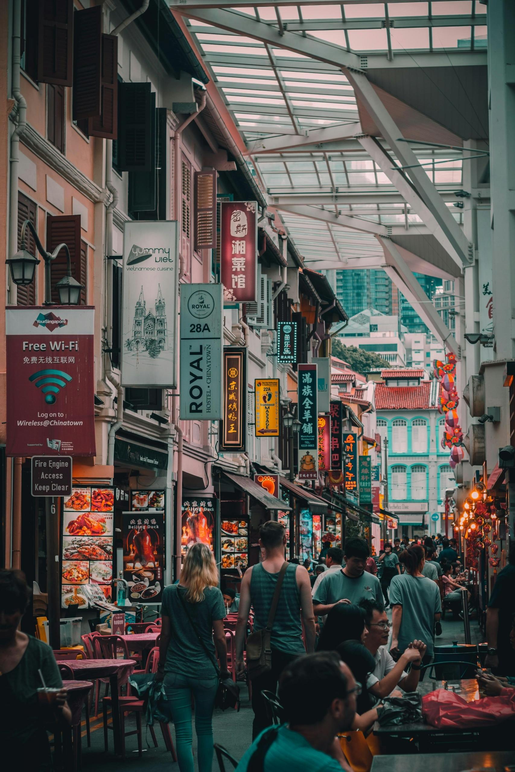 A narrow covered alley featuring pocket shops and pedestrians. 