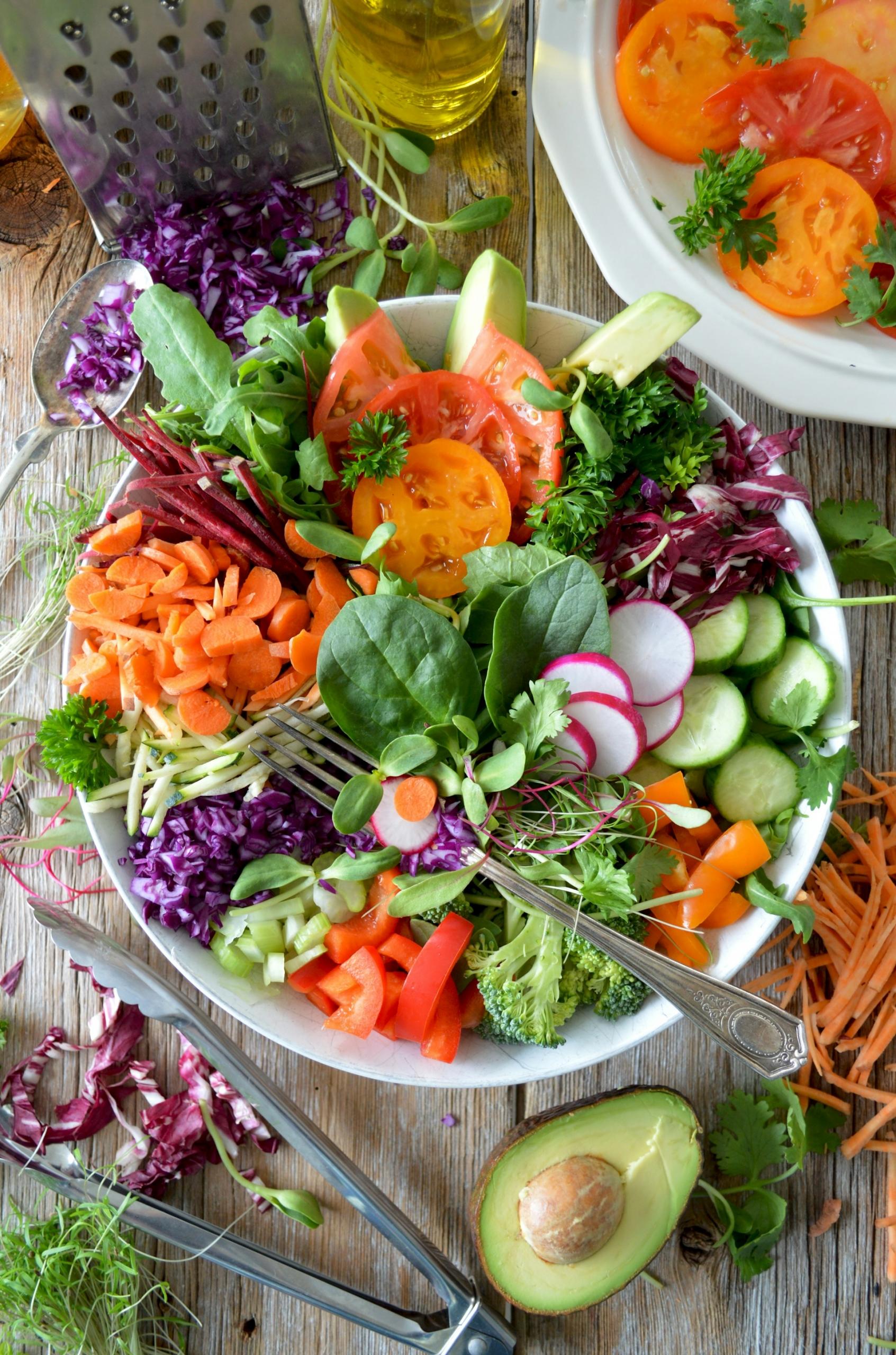 A large salad containing many different leafy greens and vegetables