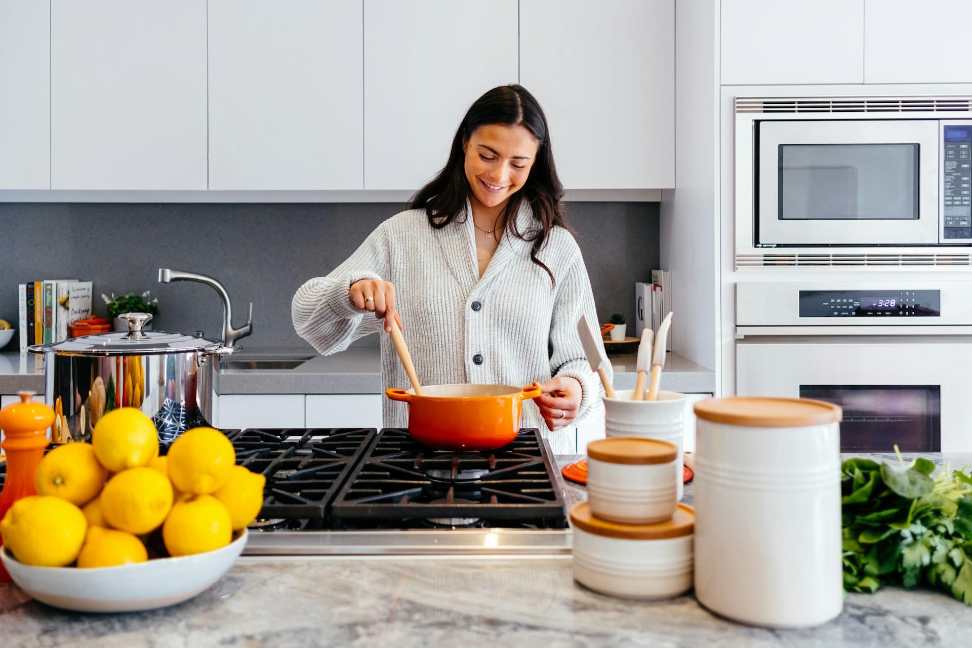 A woman cooking in a kitchen.