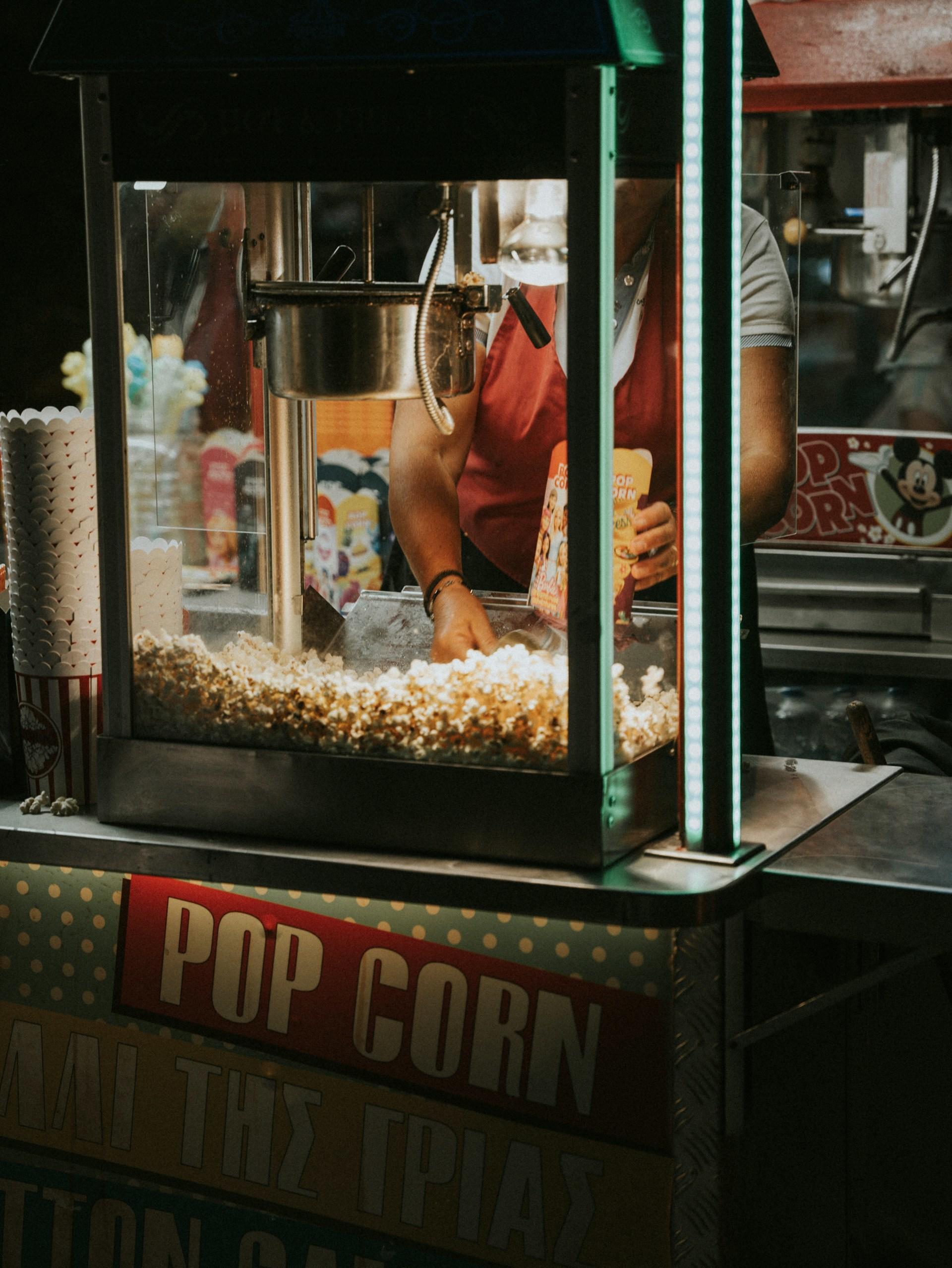 A popcorn machine with popcorn in it at night.