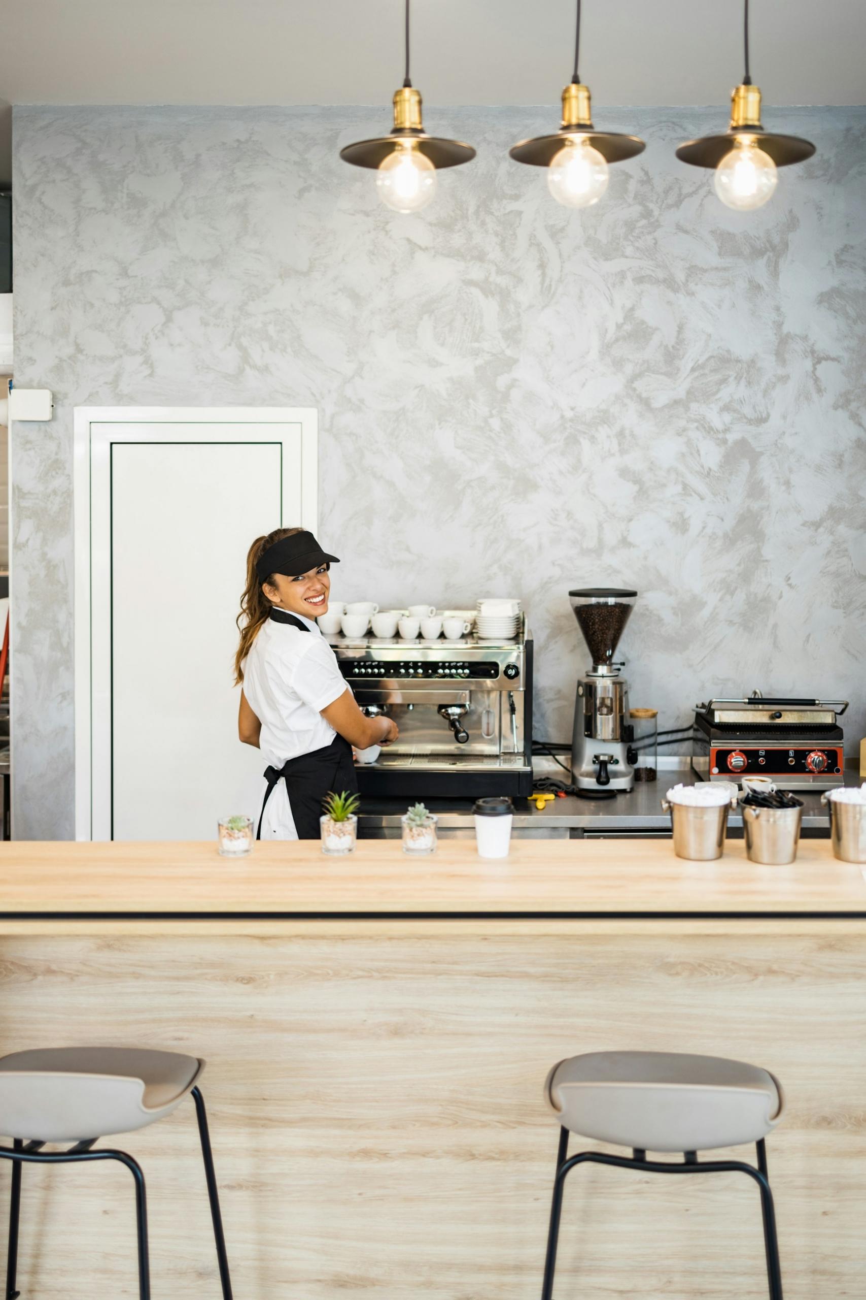 A woman behind the counter at a coffee shop.