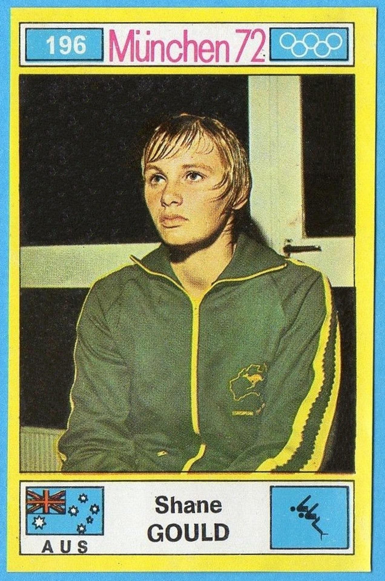 A woman in a green tracksuit and wet hair sittinng down. 