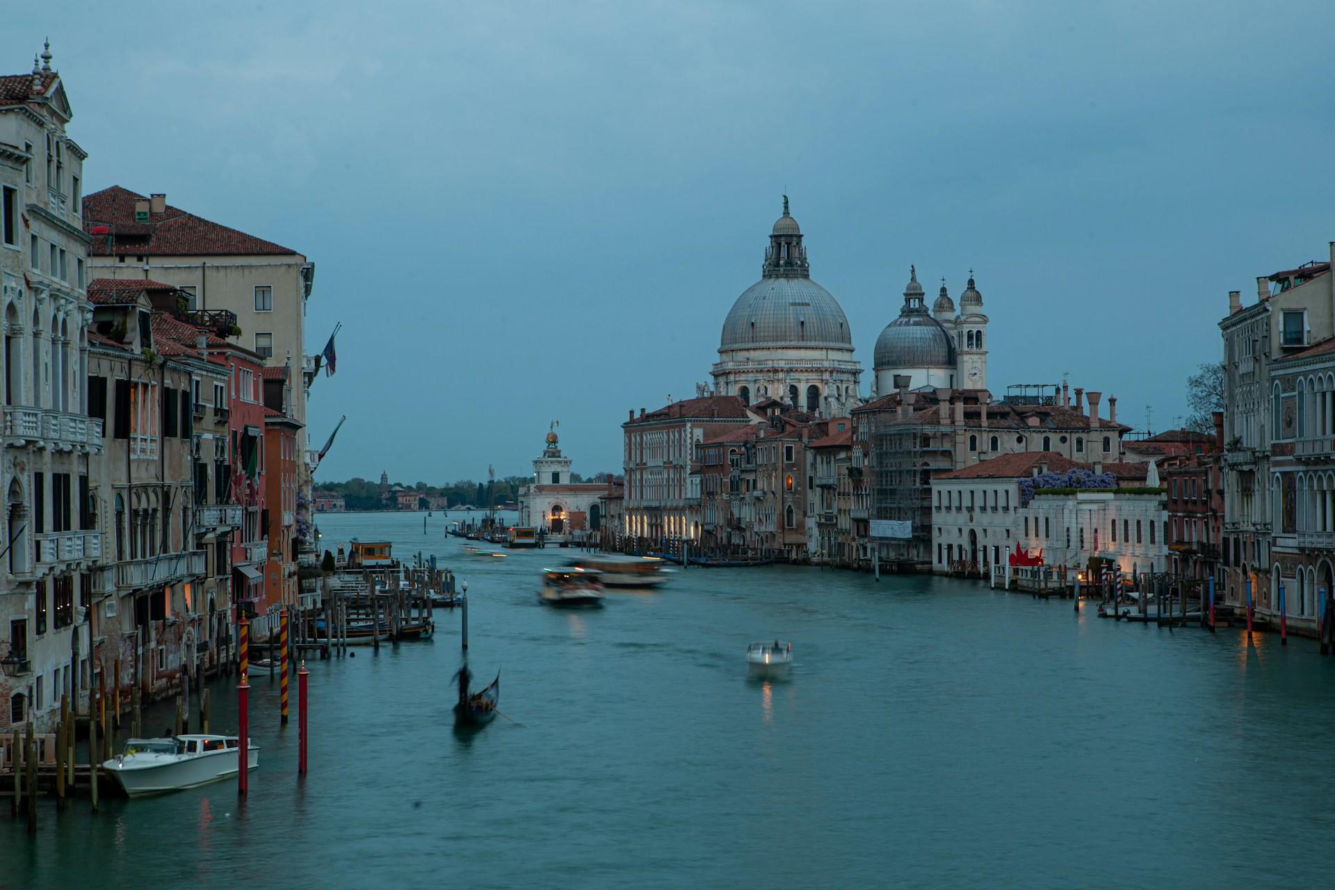 A waterway with boats and buildings in the background.