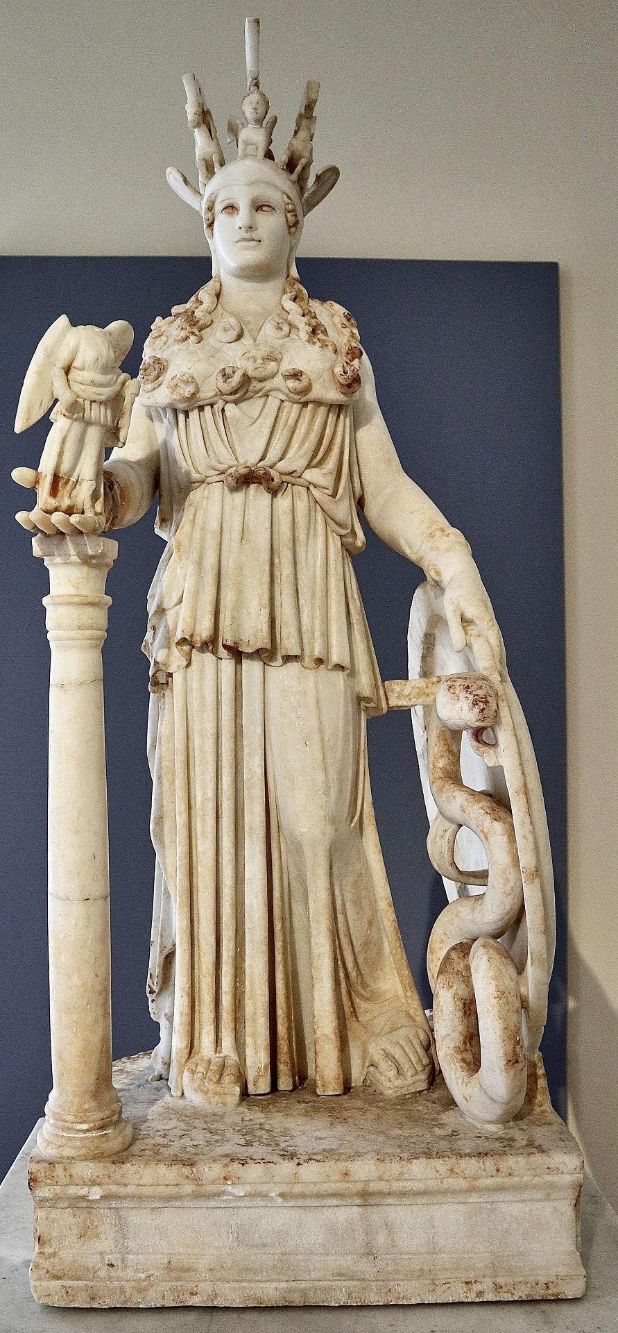 A large marble statue against a blue background.