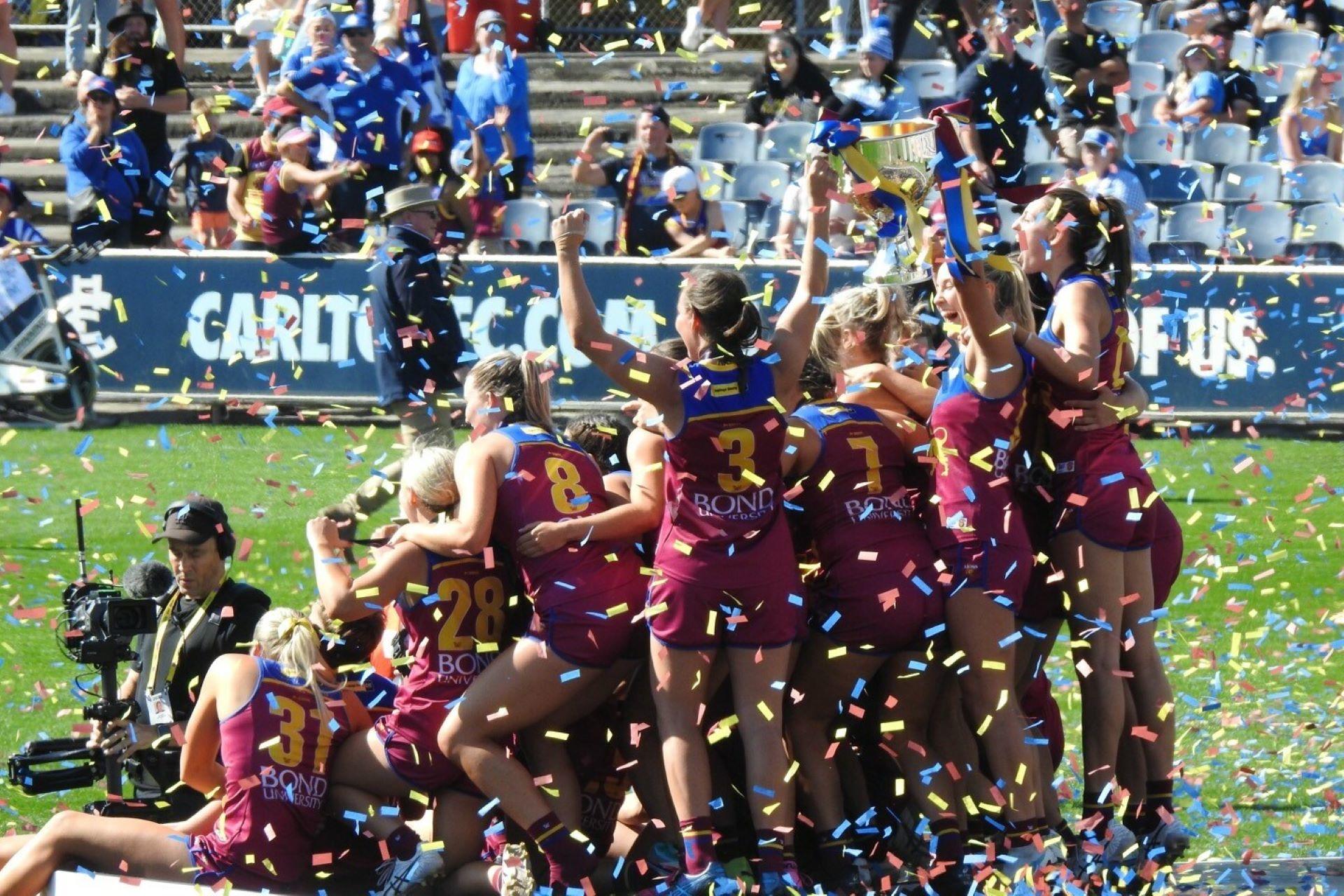 BBrisbane Lions players after being presented with the 2023 AFL Women's premiership cup.