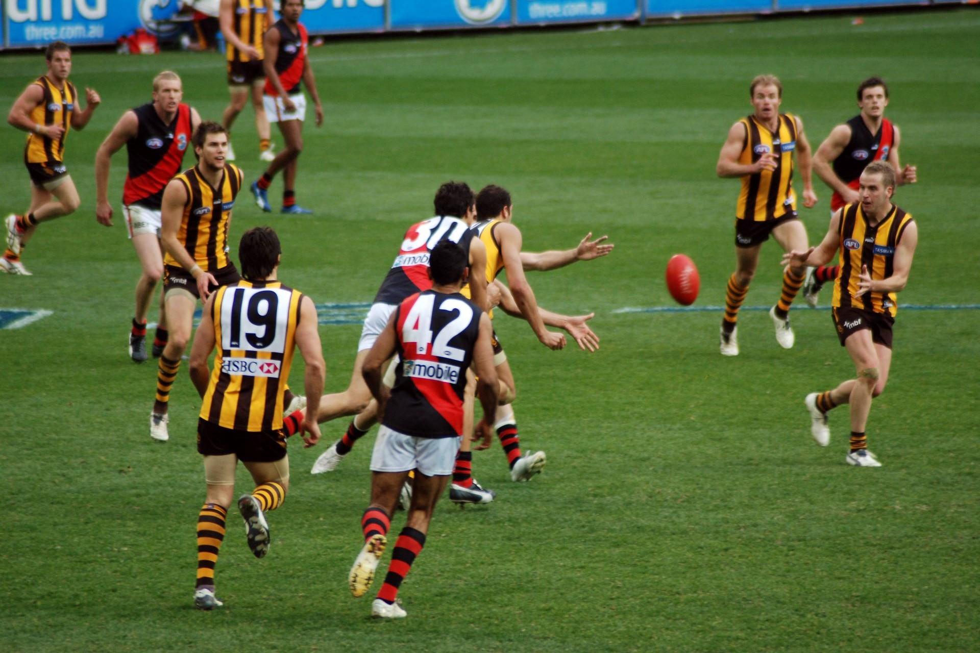Aussie rules players competing for the ball.