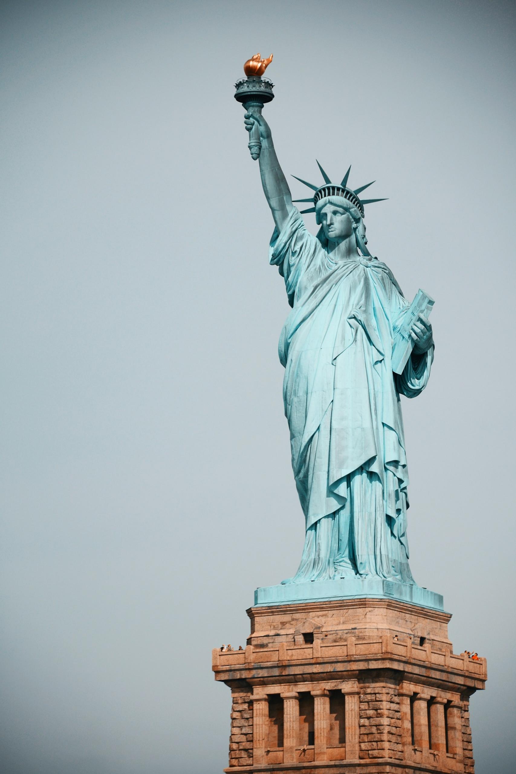 The statue of liberty on a cloudy day. 
