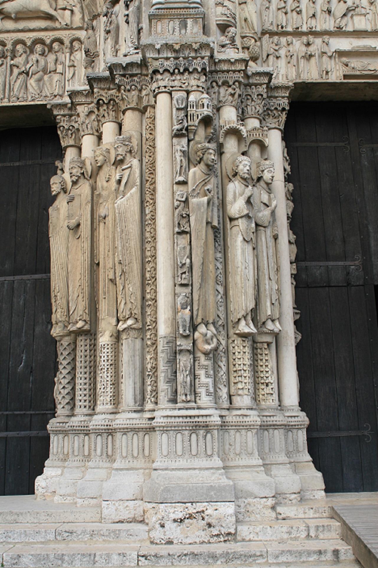 A stone column with figures carved into it. 