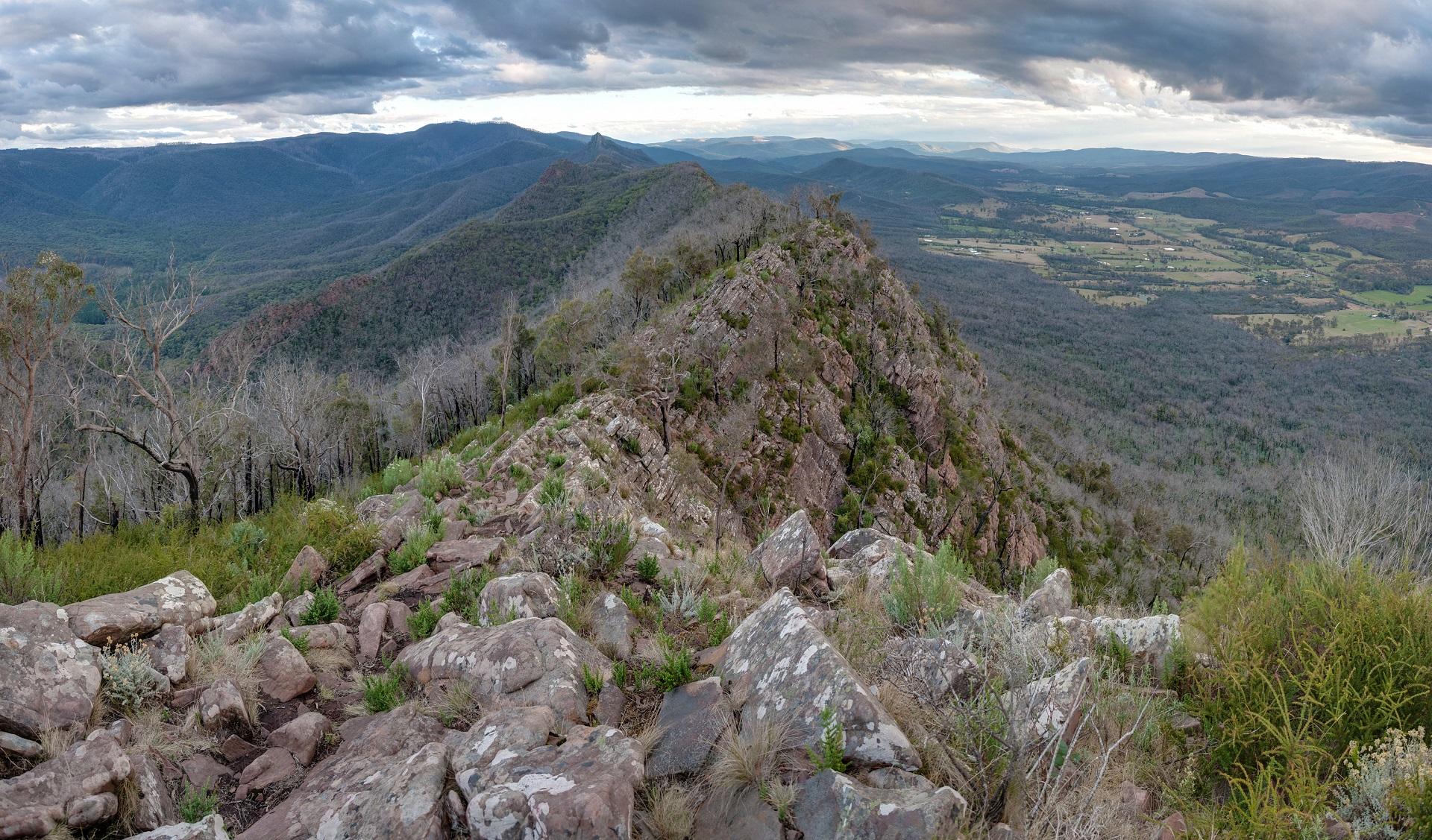 A spine of mountain ridge seen from above on a cloudy day. 
