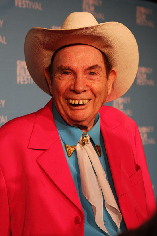 Chad Morgan wearing a cowboy hat and bright red jacket