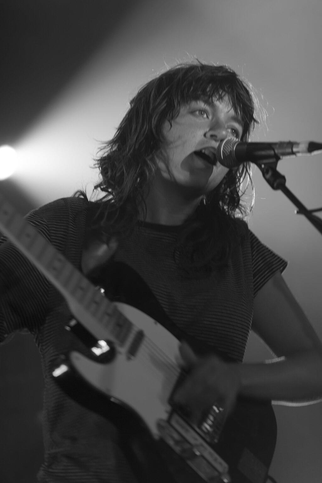 Courtney Barnett performing on stage.