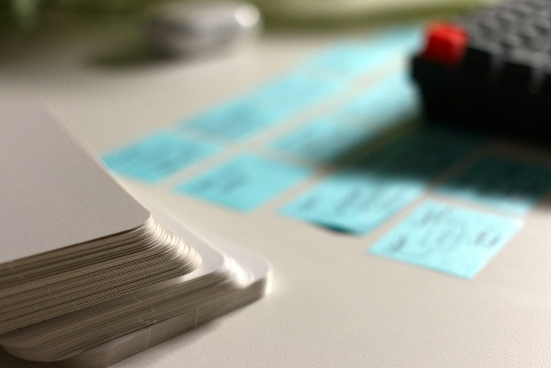 A closeup of flashcards next to post-its.