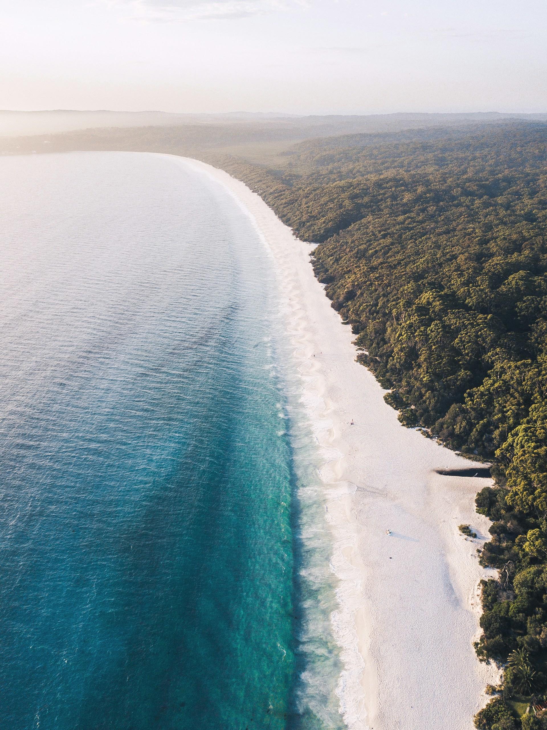 An overhead view of a coastal scene on a sunny day. 