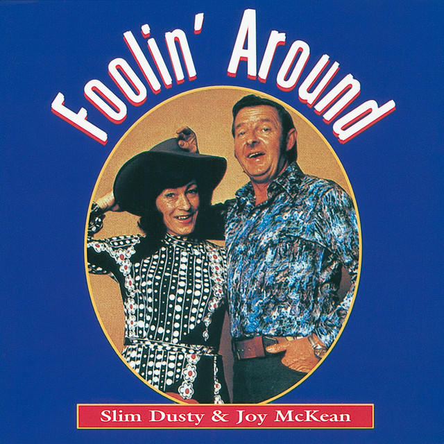 The "Foolin' Around" album cover is bright blue with an oval-shaped photo in the middle. Joy and Slim pose, both wearing patterned tops, Joy wearing a cowboy hat.