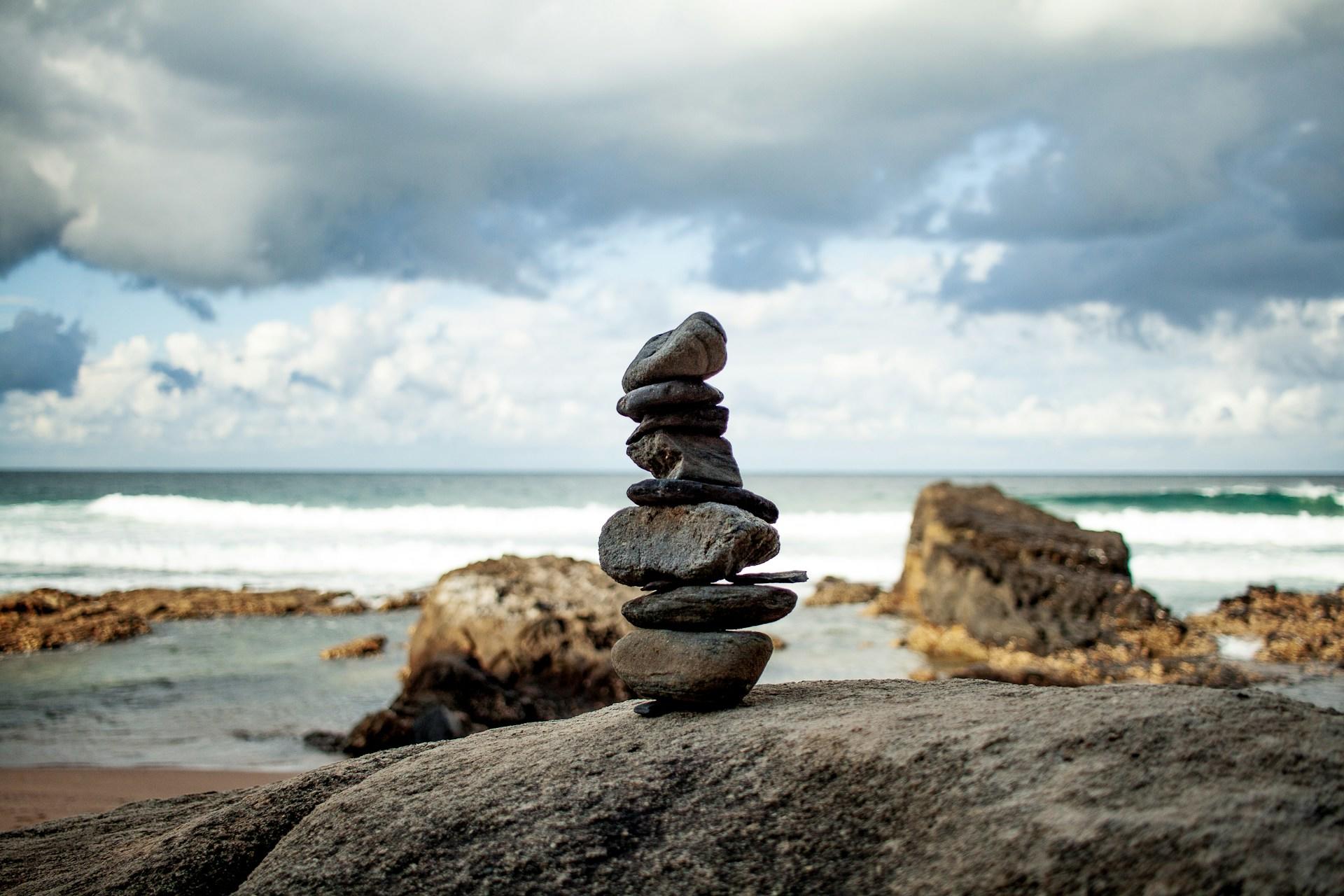 A stack of rocks balanced on a beach.