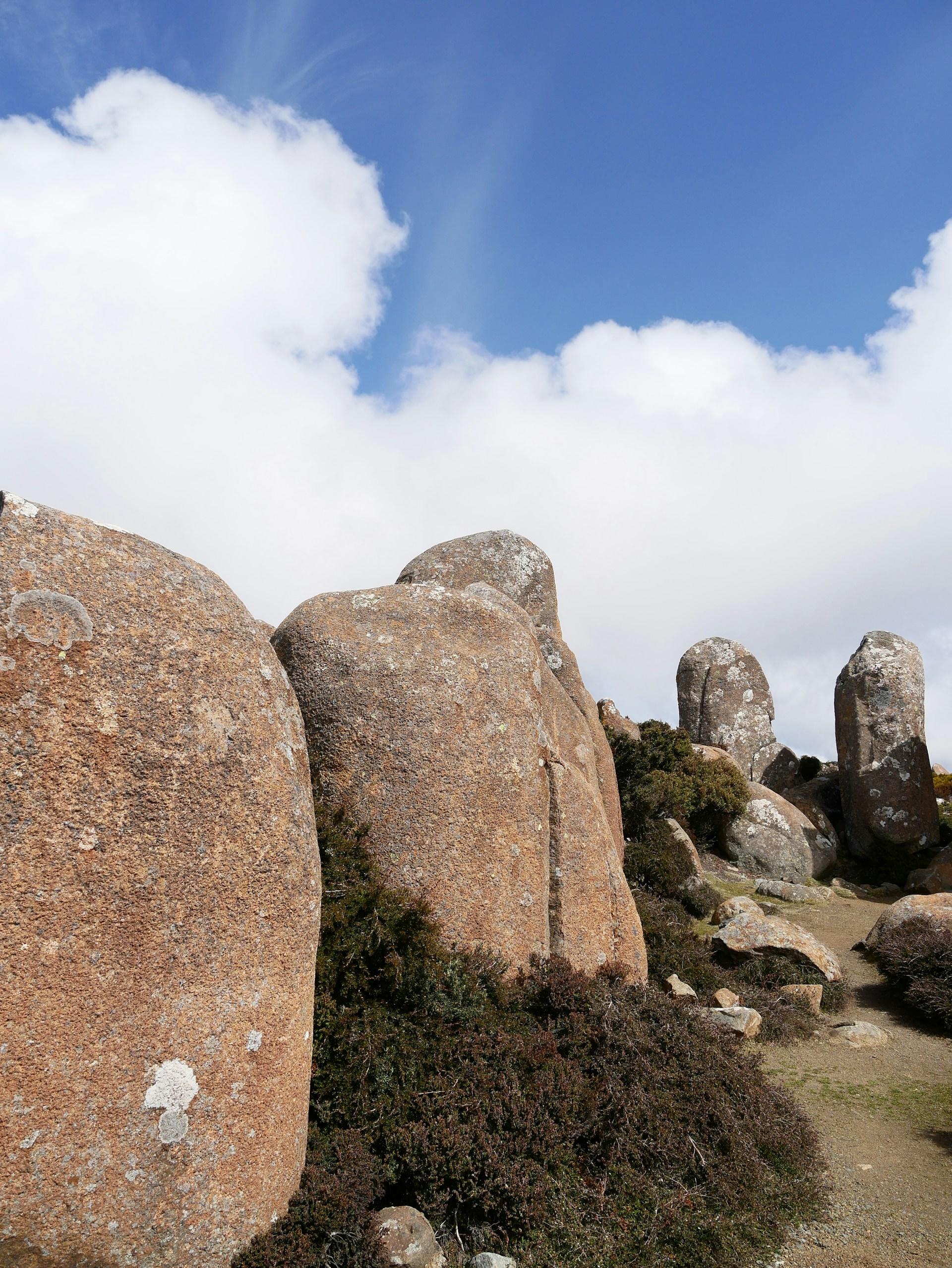 Pink granite stones on a mountain top on a partly sunny day. 