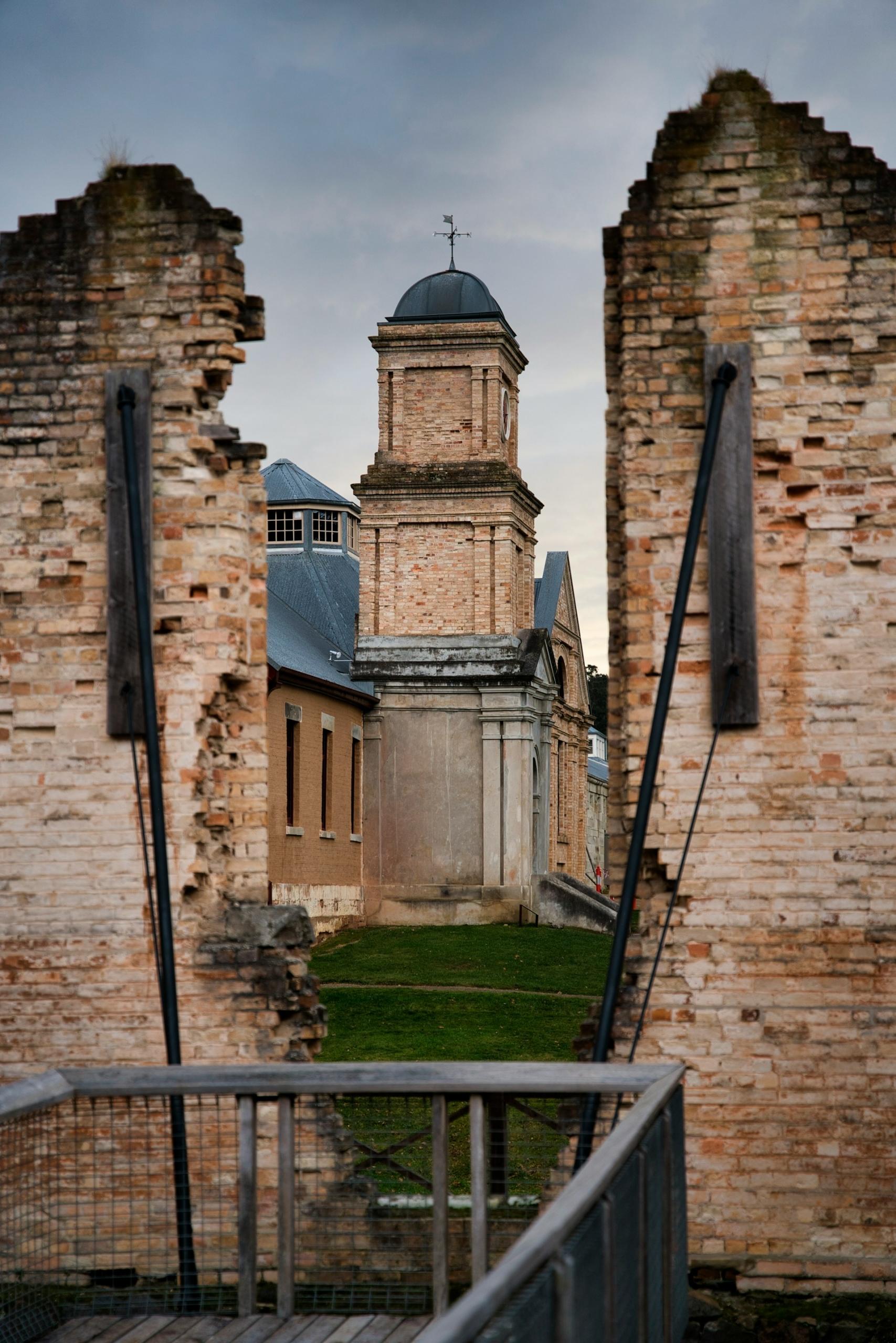 A brick gate in ruins on a cloudy day. 