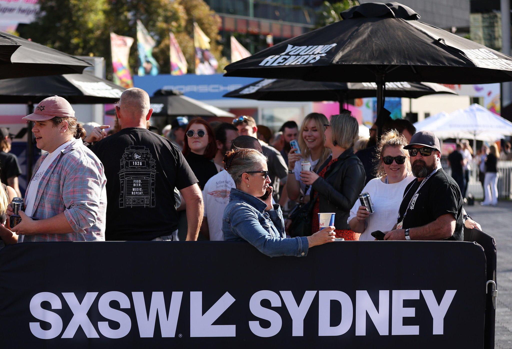 people standing near a sign reading "SXSW Sydney"