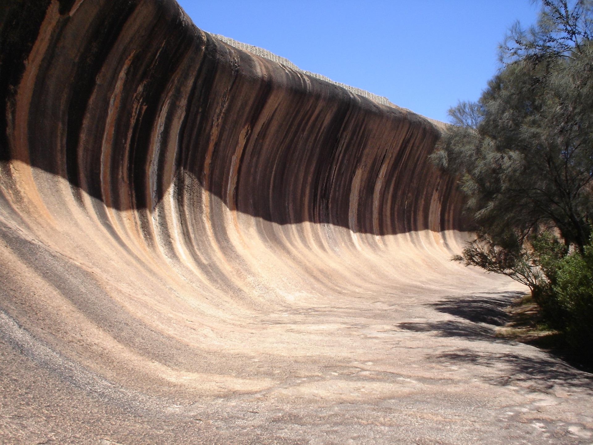 A rock formation that looks like a curling wave on a sunny day. 