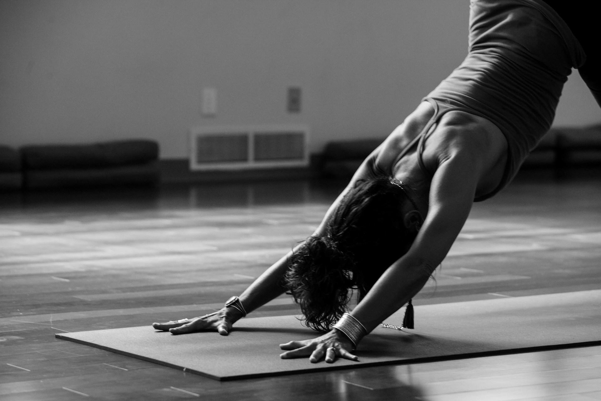 A person practising yoga on a yoga mat.