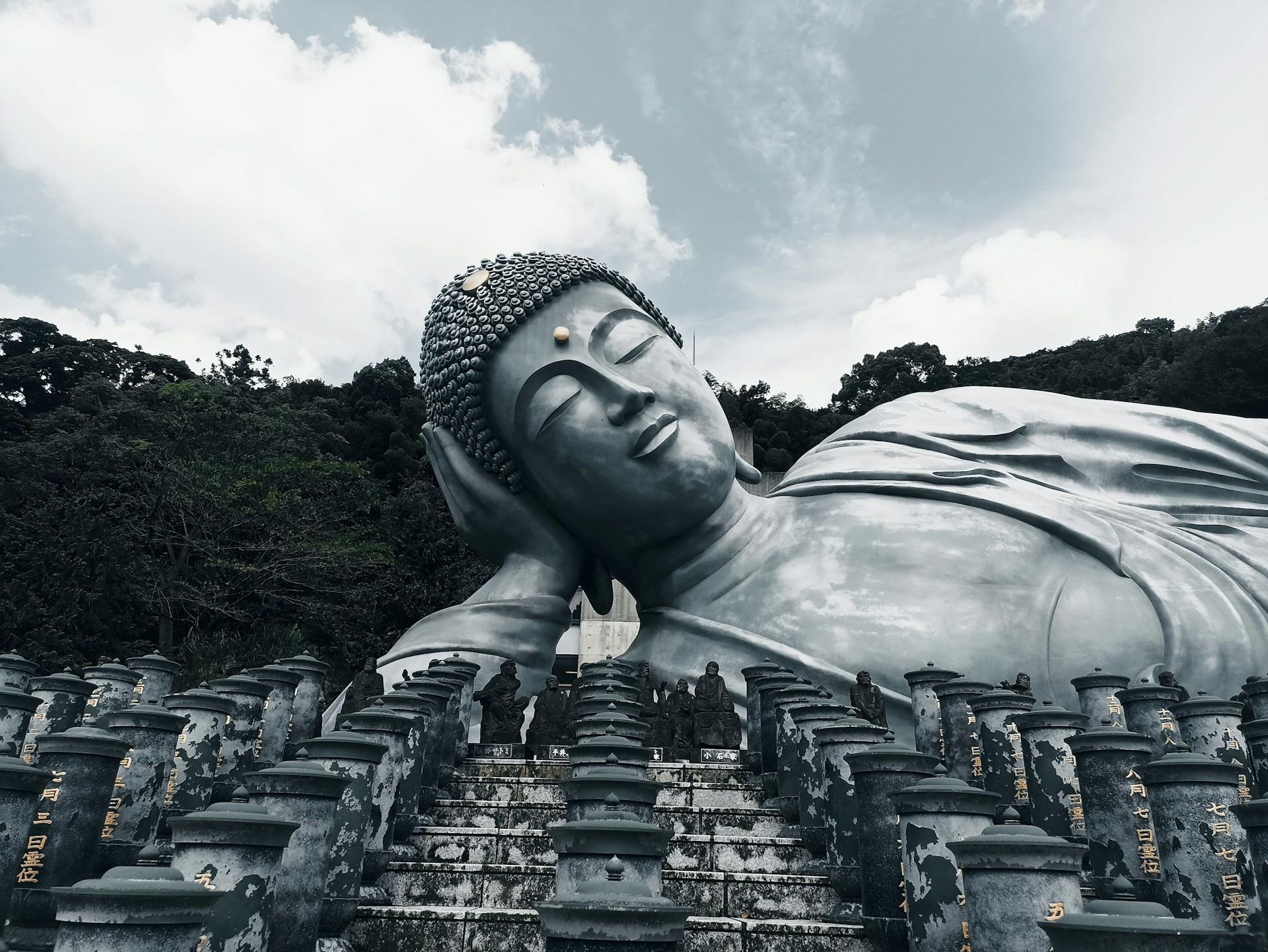 A large reclining Buddha on a cloudy day. 