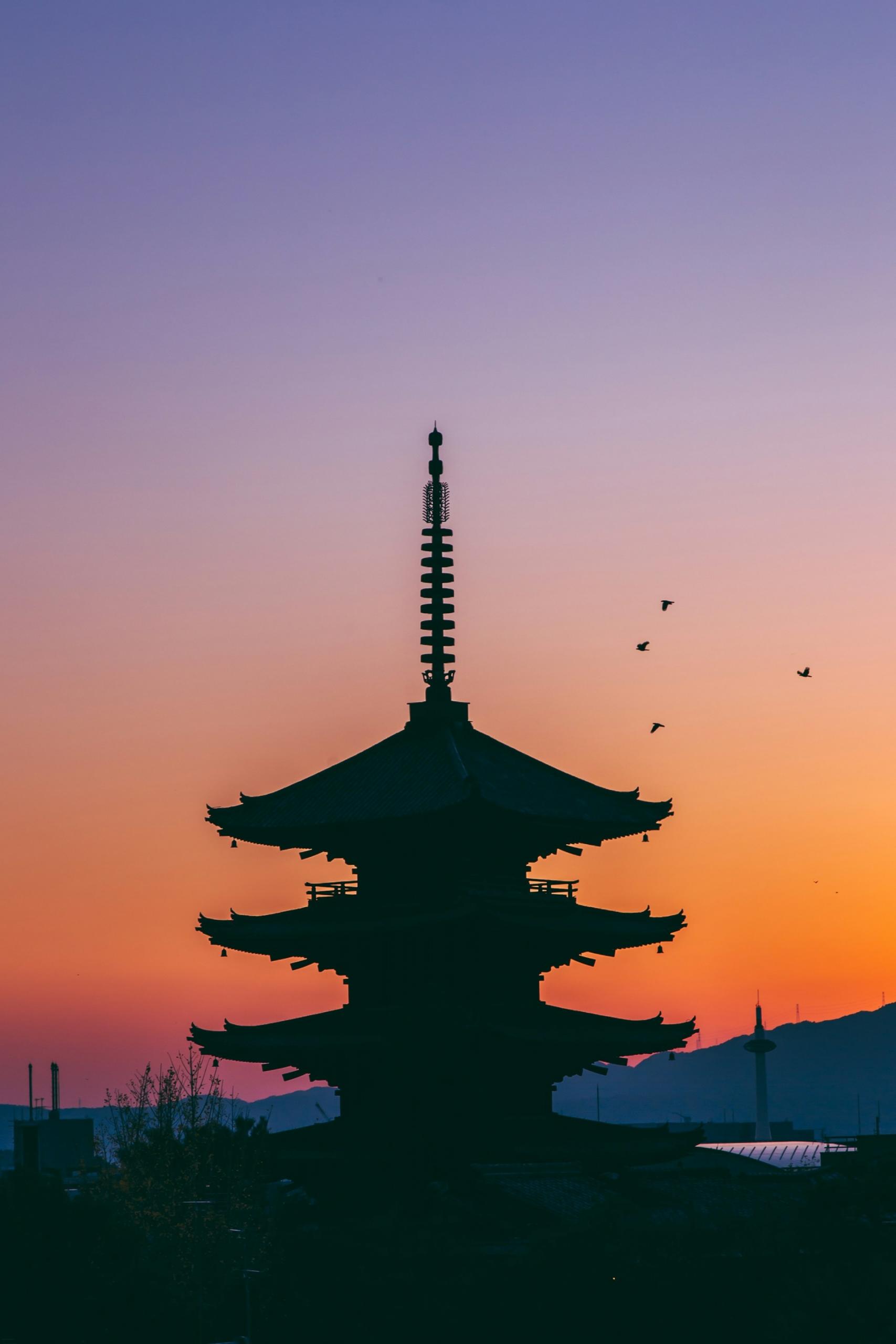 A pagoda in silhouette at sunset. 