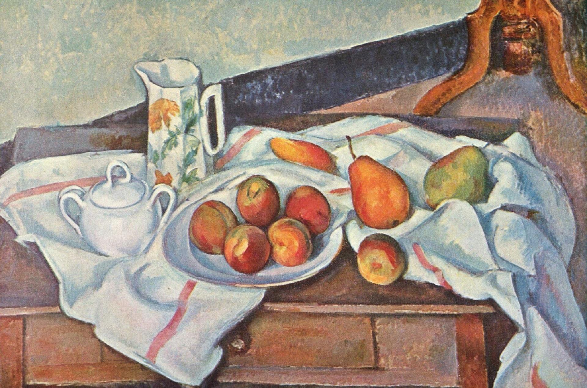 A small table with a white cloth, a pitcher an bowl, and a plate of fruit.