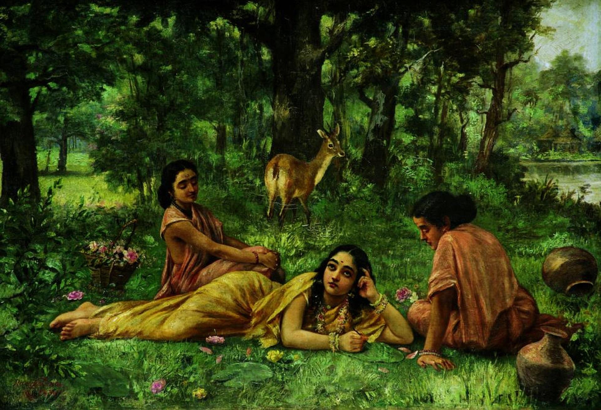 Three women lounge in a green space with a deer in the background.
