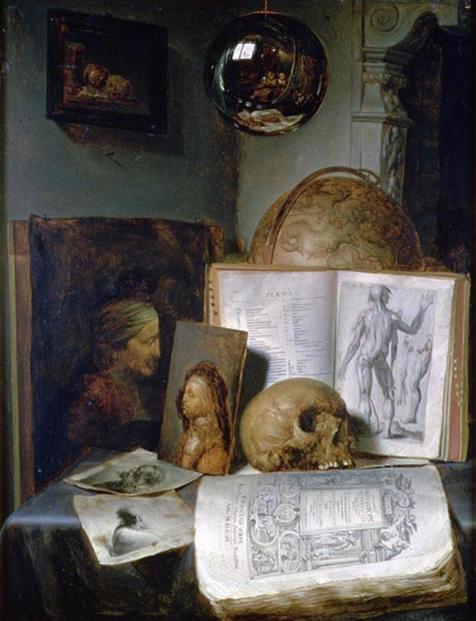 A skull in front of an open book propped up, on a table.