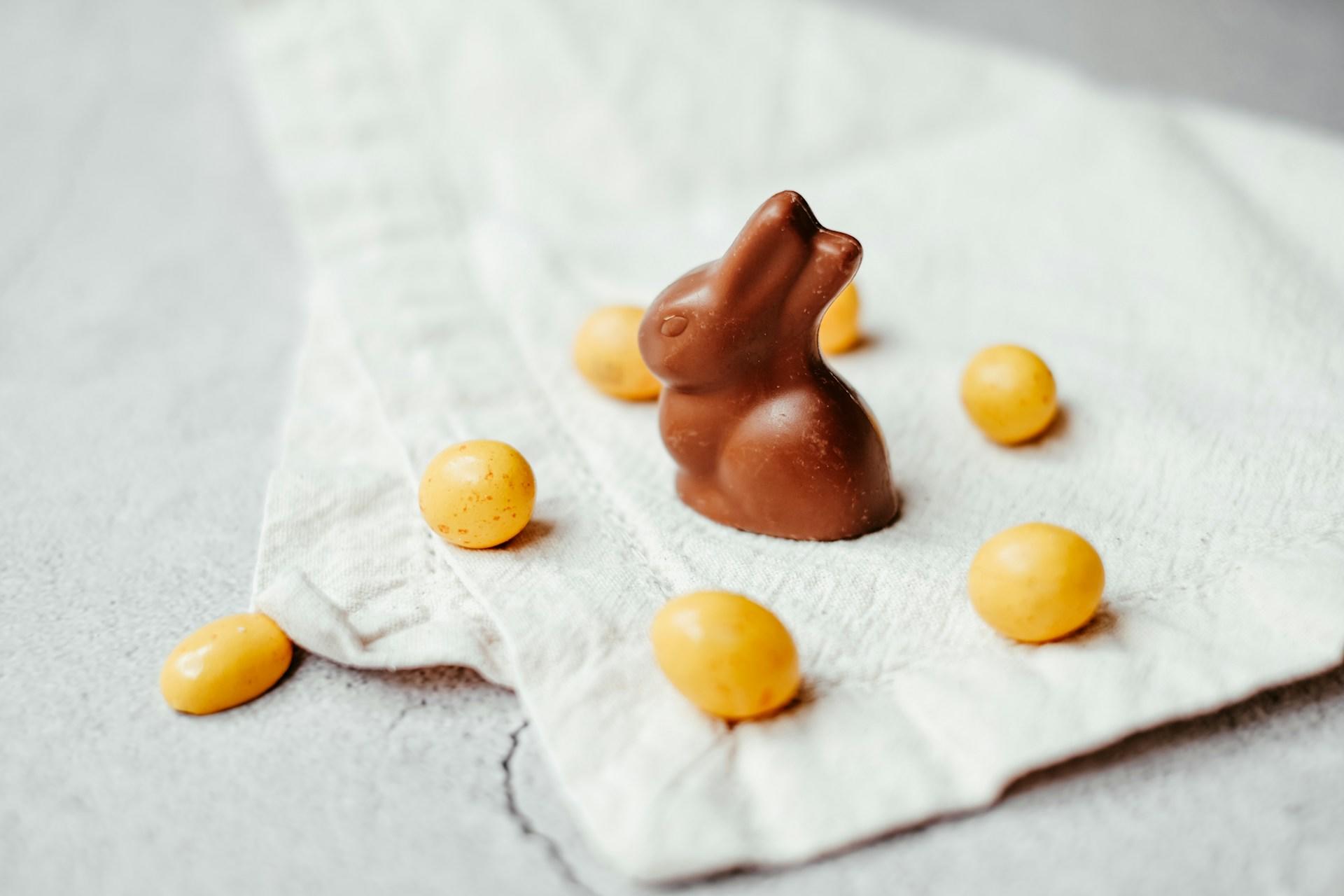 A small chocolate bunny on a white wrapper. 