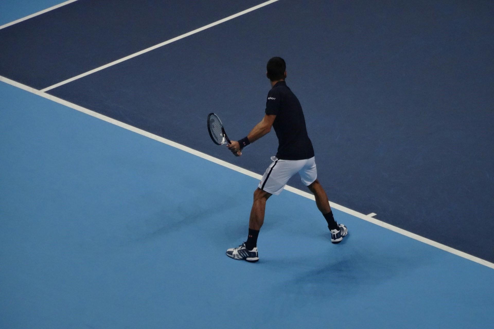 A man on a hard tennis court.