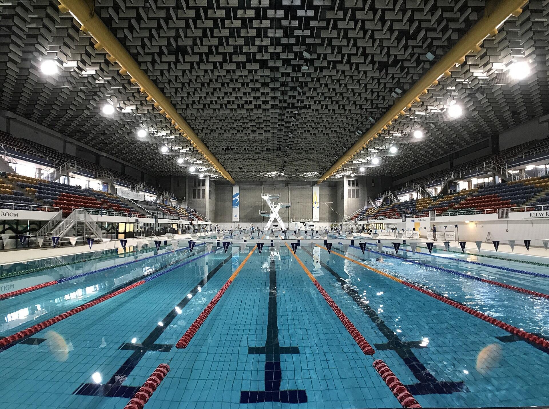 An indoor swimming pool empty of swimmers.