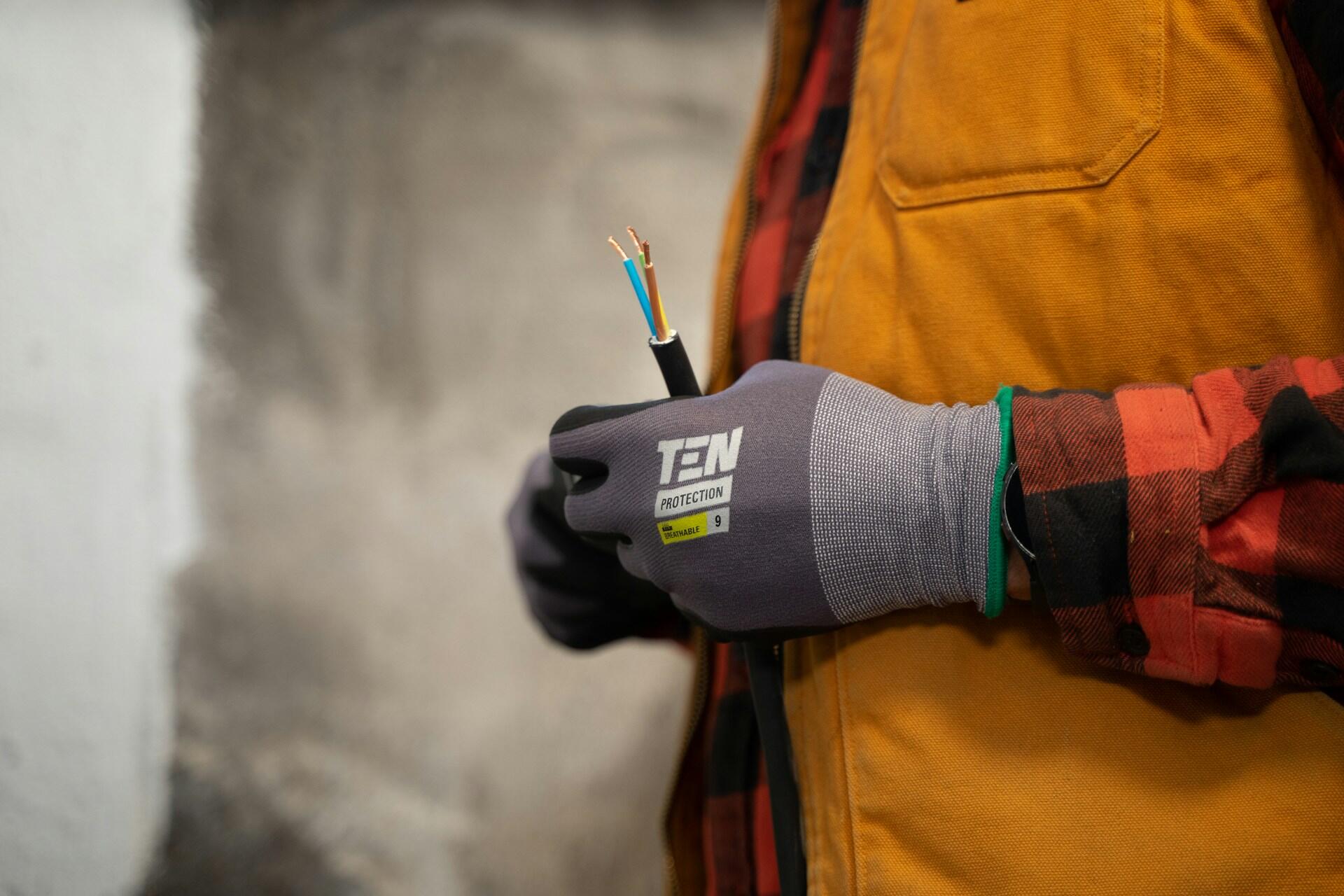 An electrician wearing protective gloves.