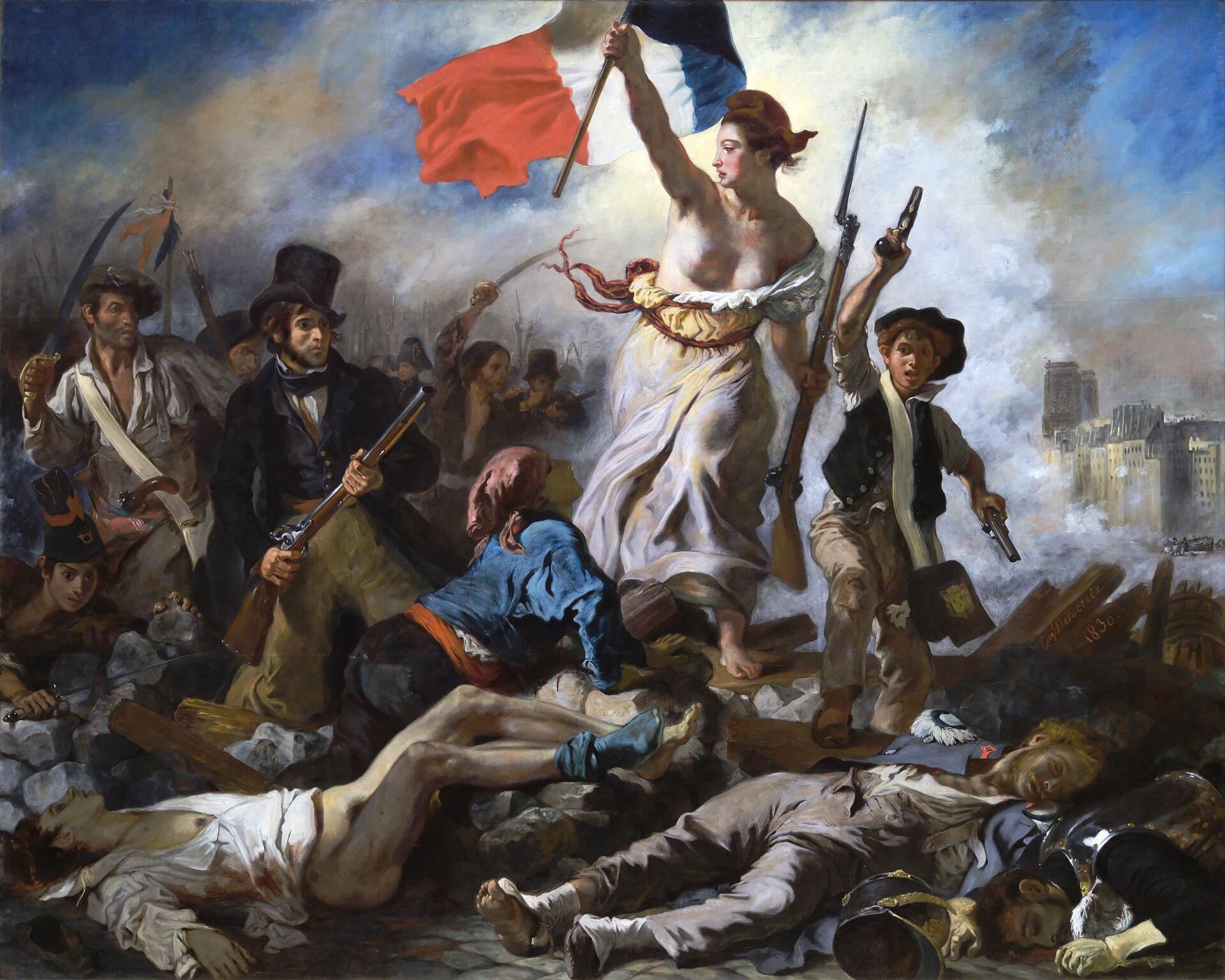 A woman holding a French flag aloft and looking behind her.