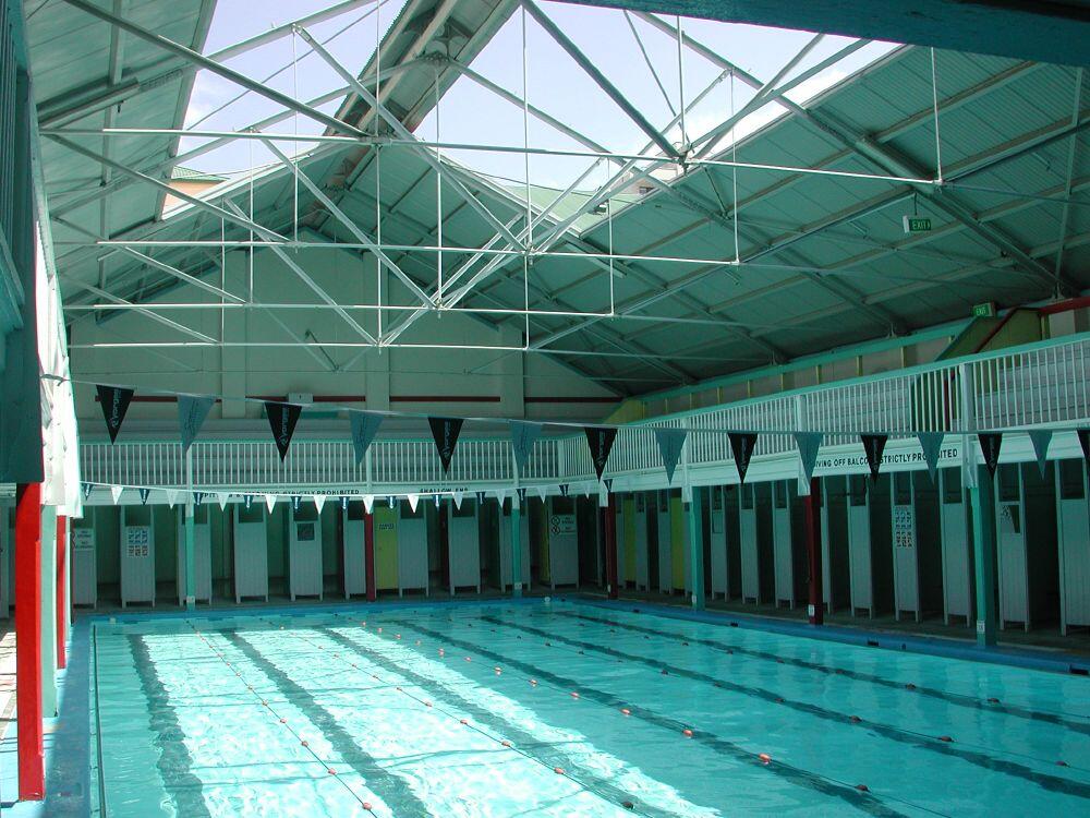 An indoor swimming pool with no people swimming.