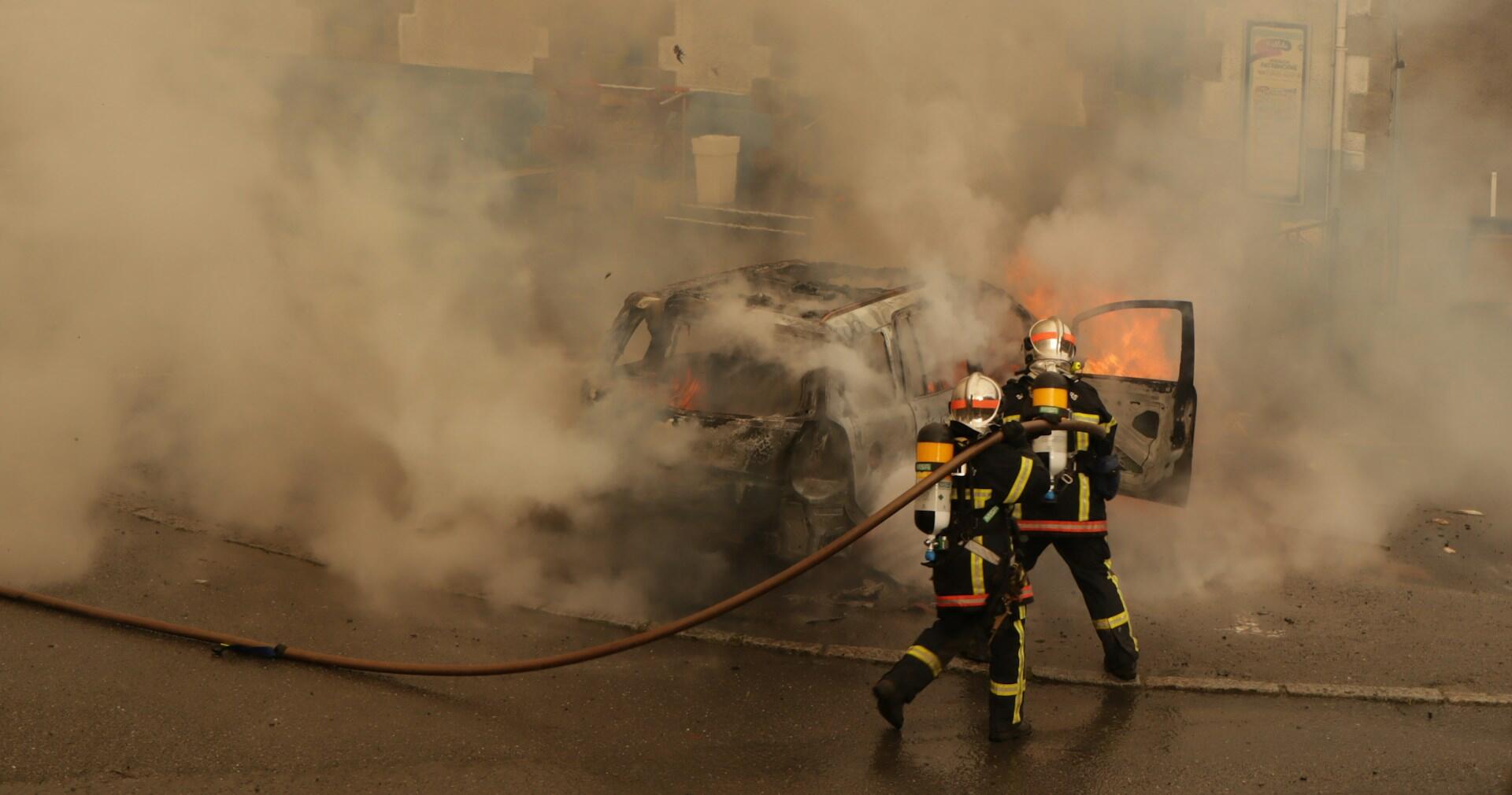 firefighters putting out a car fire