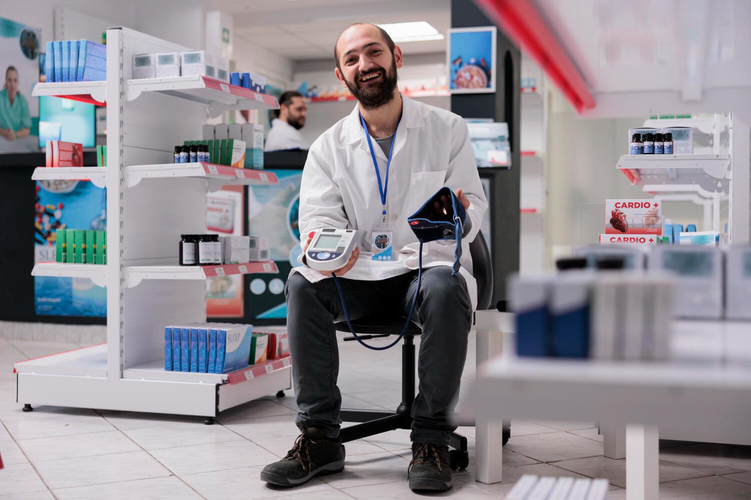 a Pharmacist holding a blood pressure cuff machine