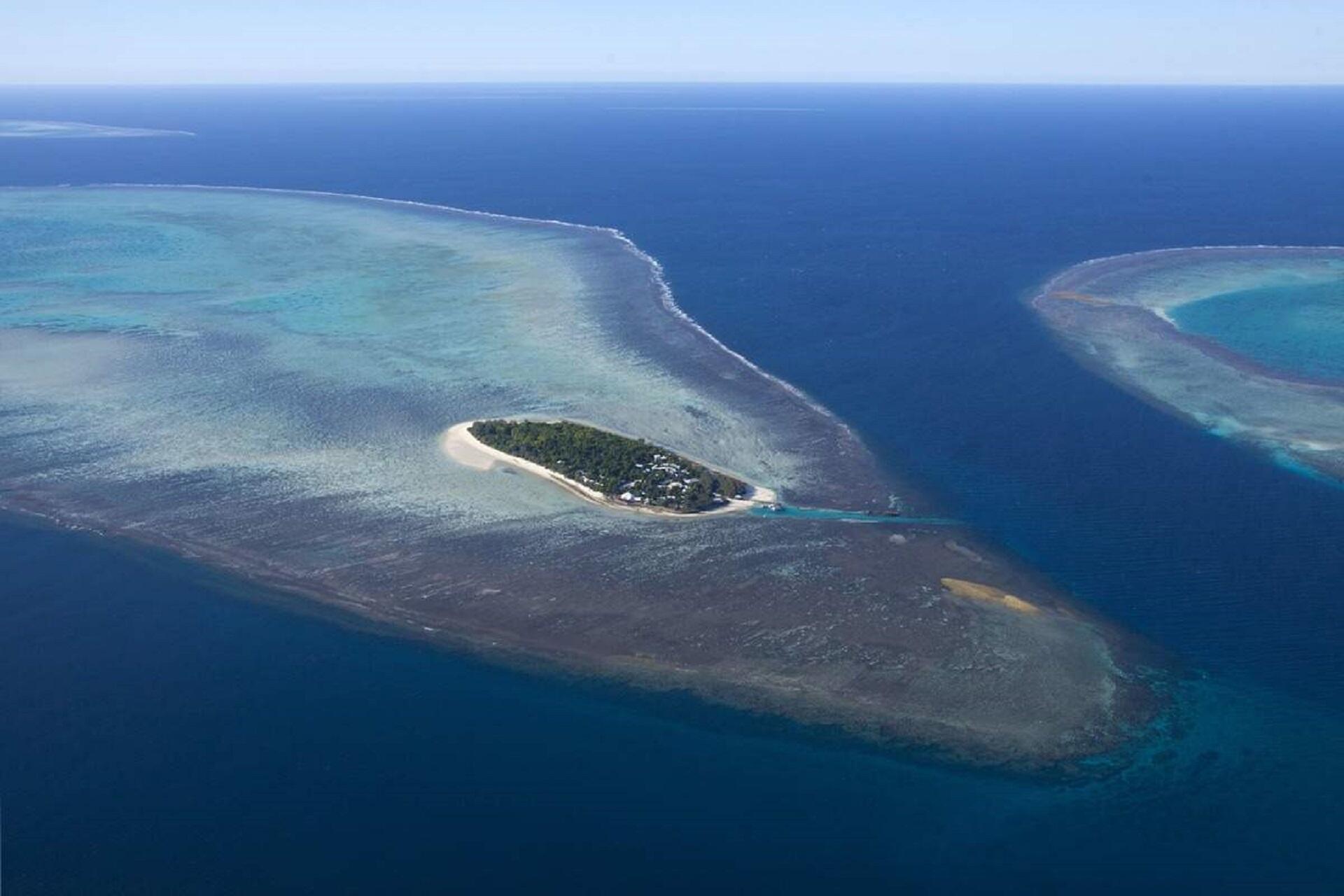 An island surrounded by blue water.