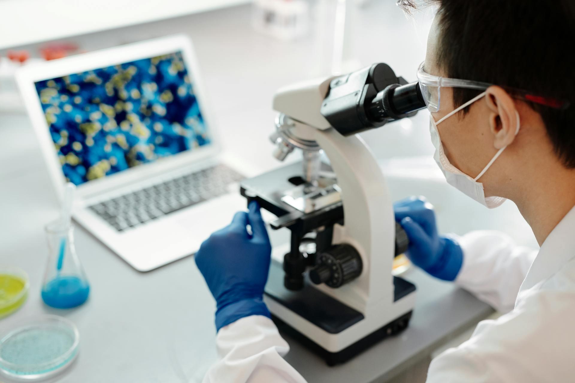 a scientist using a microscope.