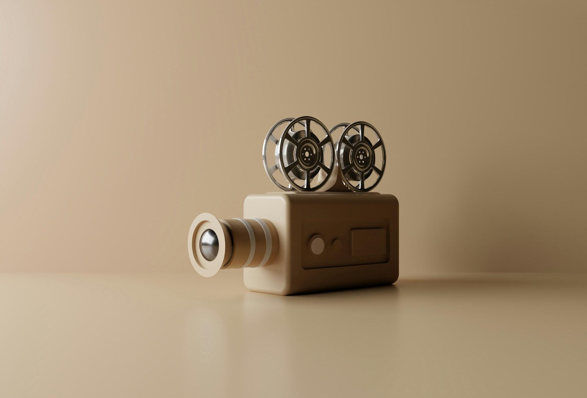 A retro-style film projector in a warm beige tone, featuring two metallic reels and a cylindrical lens.