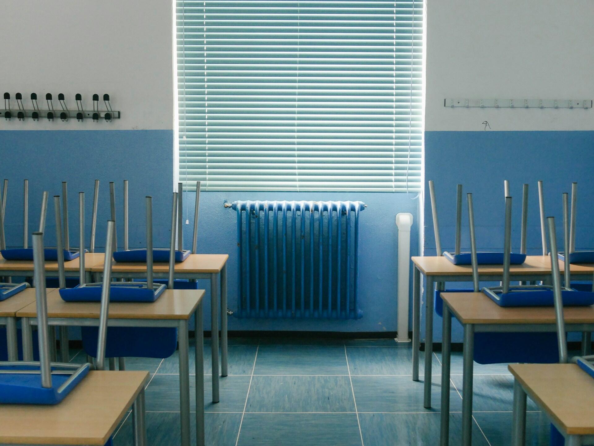 An empty classroom with blue walls.