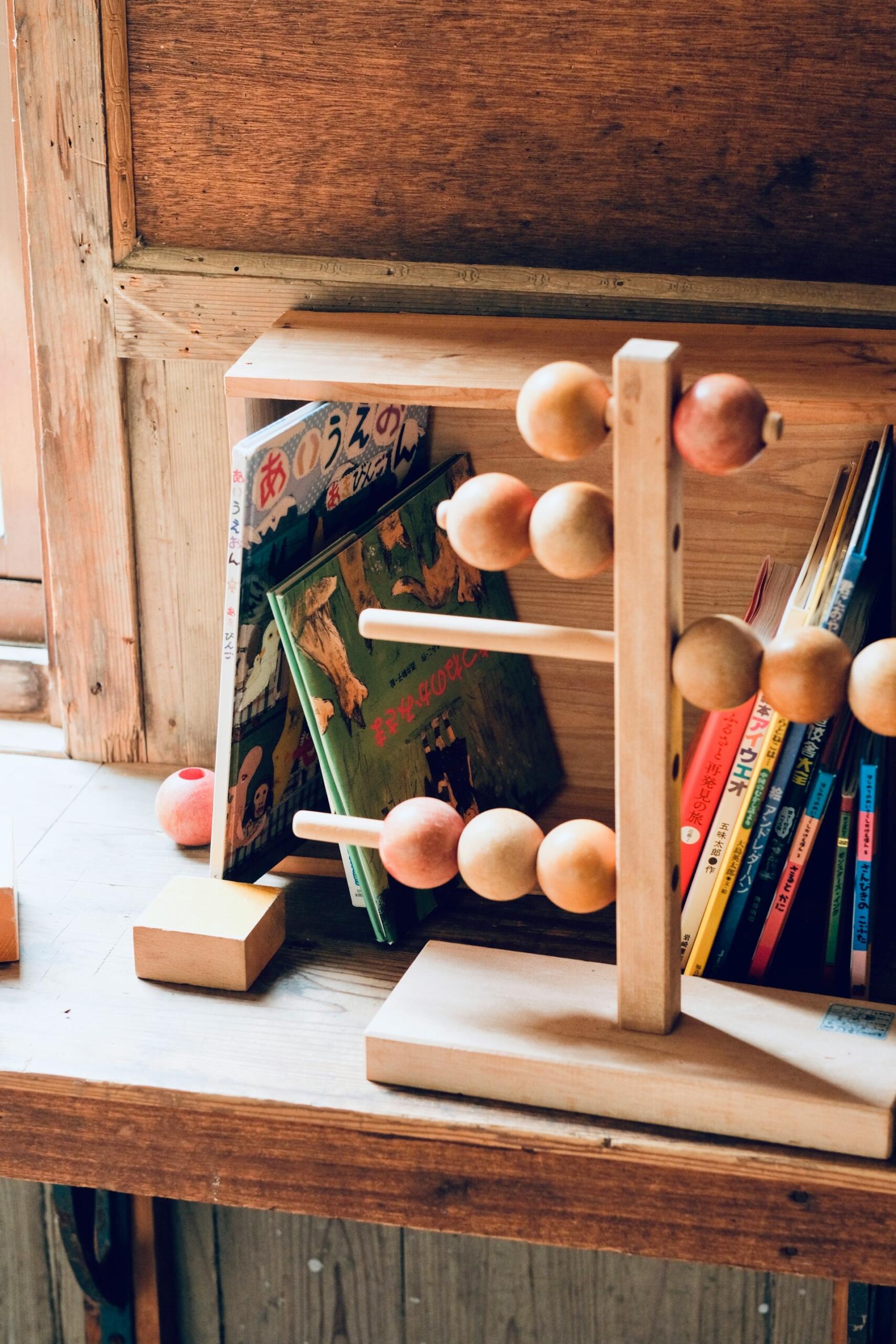 A wooden structure in front of books inn a classroom. 
