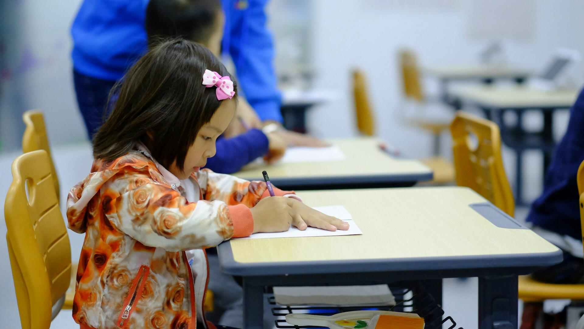 A primary school student at their desk.